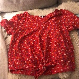 Floral blouse. Red with white and blue flowers.